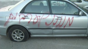 A car vandalized with graffiti.