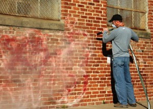 Removing graffiti from brick. 